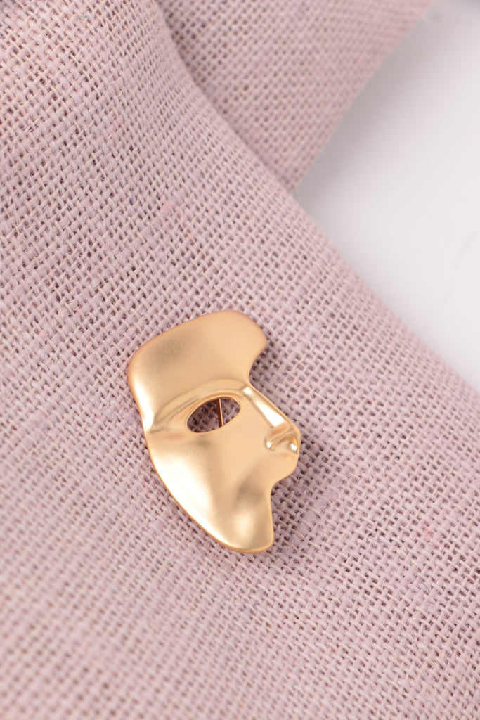 face brooch