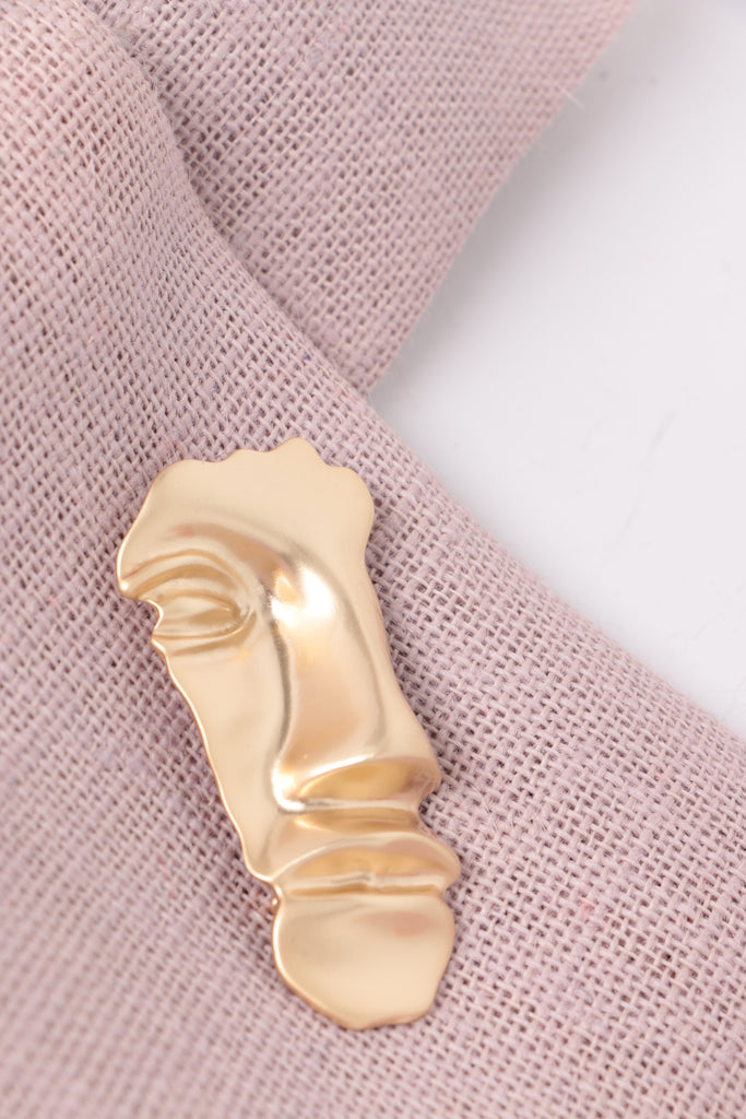 face brooch